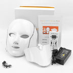 LED beauty mask set with packaging, mask, and power adapter on a white background