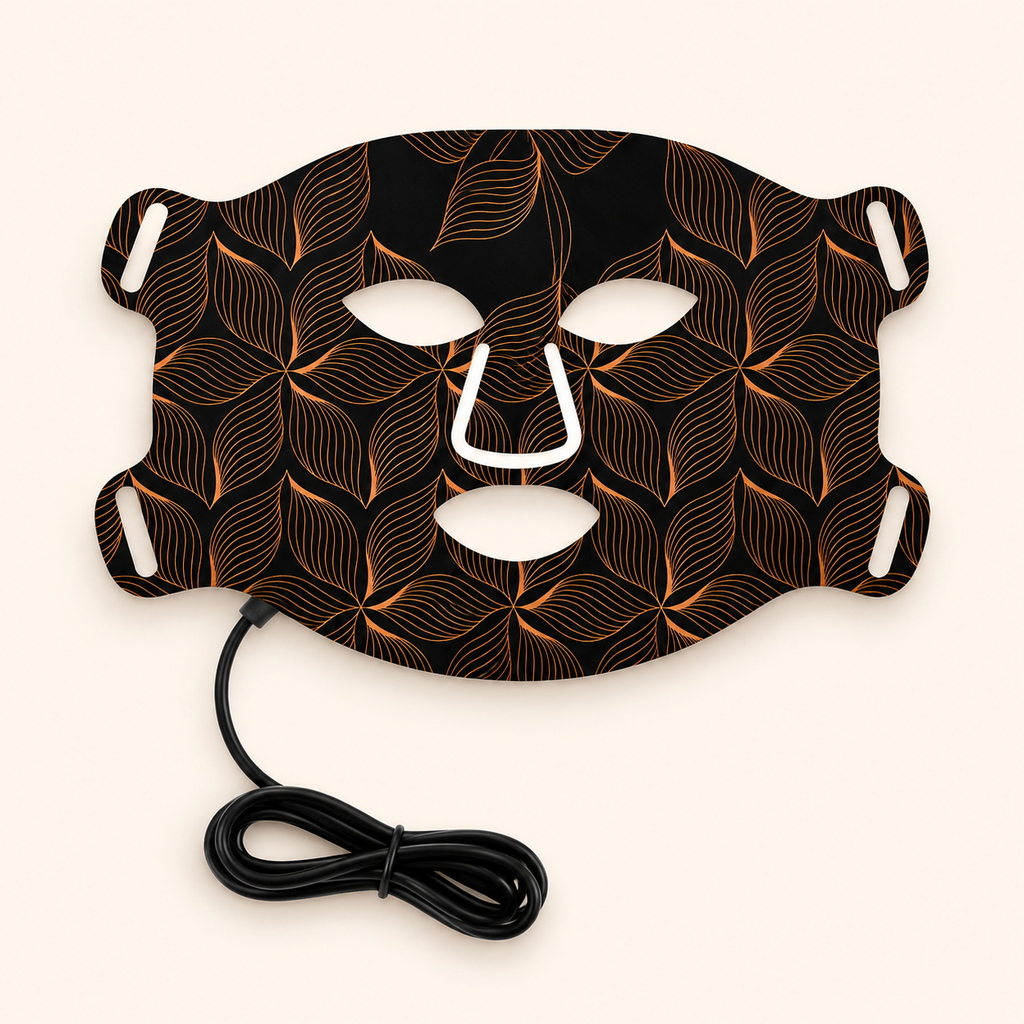 Black face mask with leaf pattern and white accents on a white background