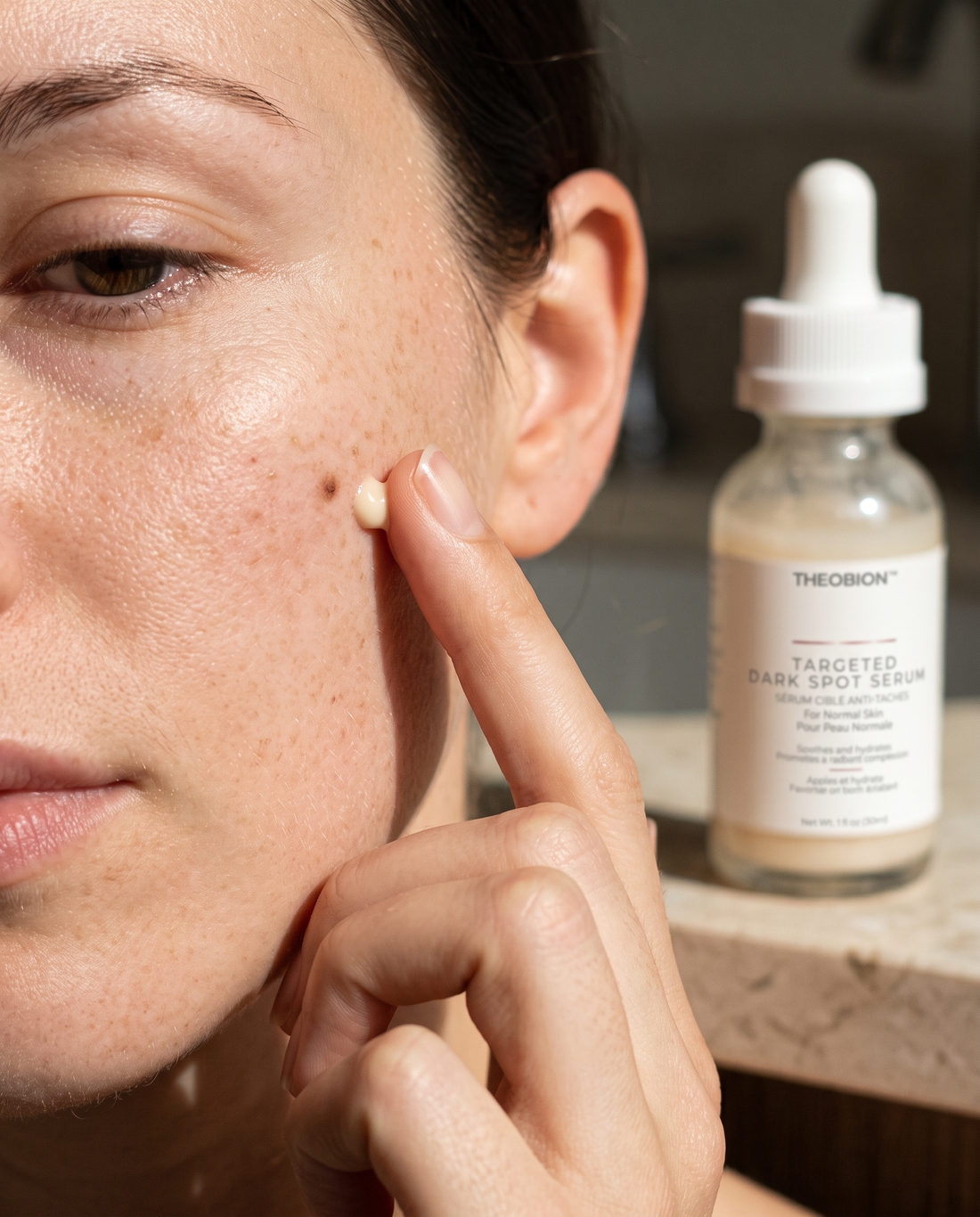 Fingertip dabbing Targeted Dark Spot Serum onto a dark spot